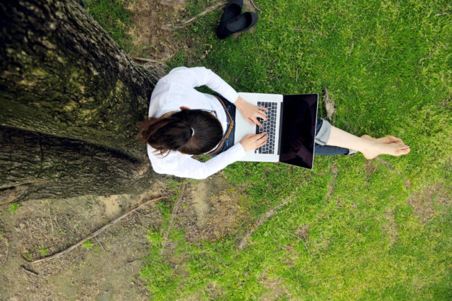 woman with laptop in park AAT Homework